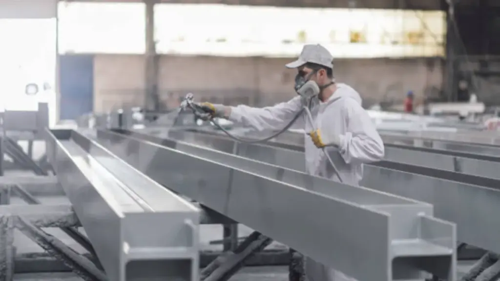 man painting in a factory