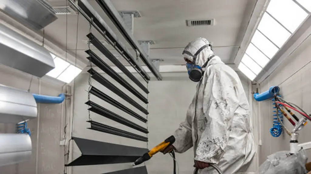 The craftsman paints structural elements in the painting booth