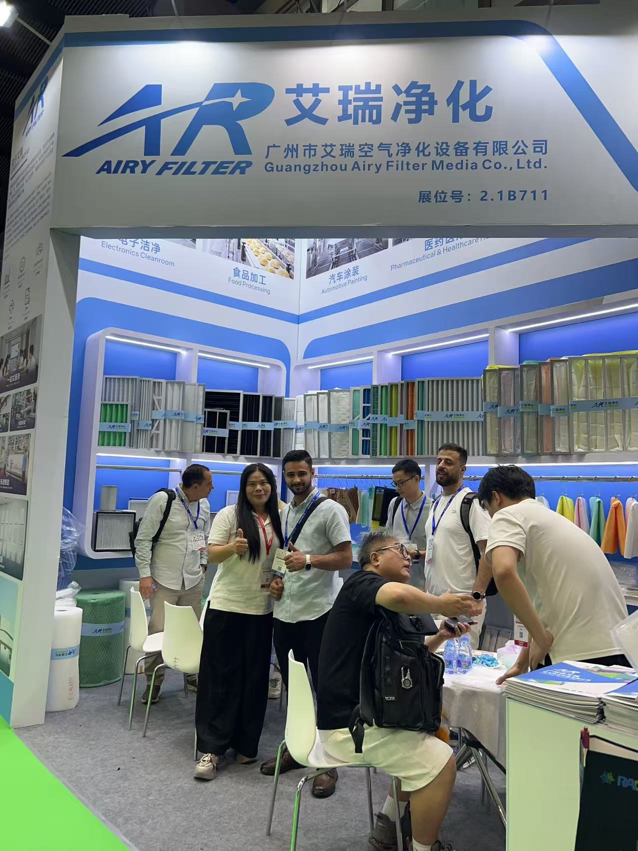 AIRY staff discussing air filtration media specifications with overseas visitors at the booth