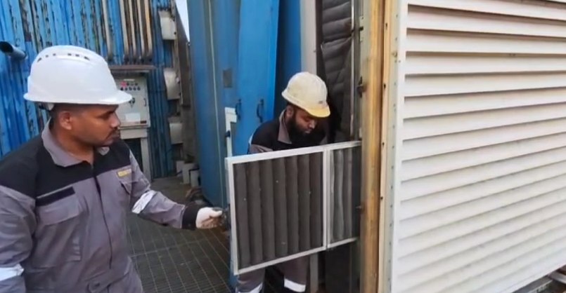 Technician installing an AHU panel filter